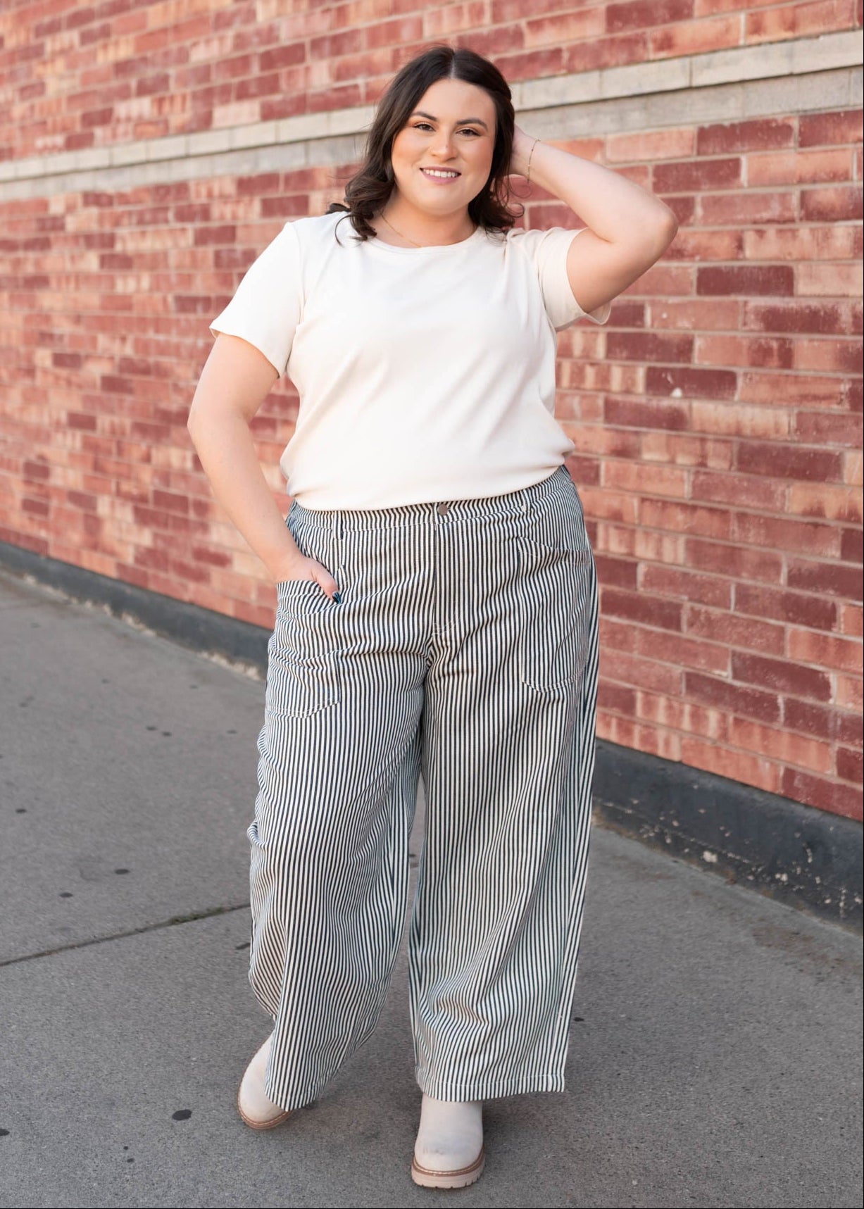 Plus size navy pinstripe pants with wide leg and front and back pockets sold at Lena Layne