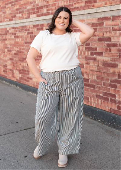 Plus size navy pinstripe pants with wide leg and front and back pockets sold at Lena Layne