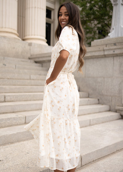 Side view of the modest cream floral smocked dress with pockets at Lena Layne