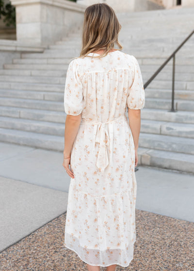 Back view of the modest cream floral smocked dress with a tie in the back