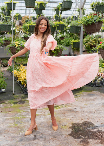 Front view of the pink floral textured dress