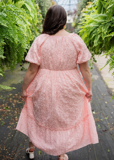 Back view of the plus size pink floral textured dress