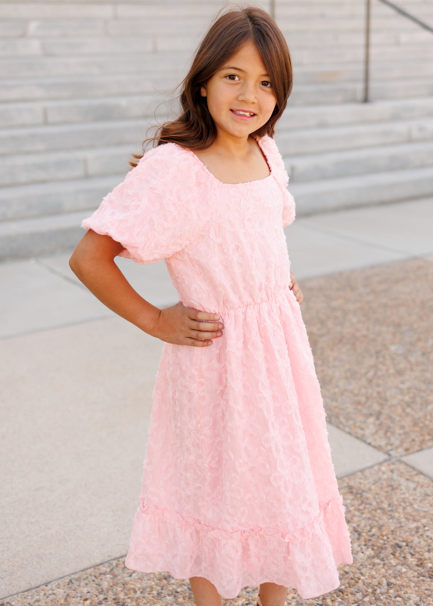 Side view of the pink floral textured little girl dress