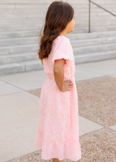 Side view of the pink floral textured little girl dress