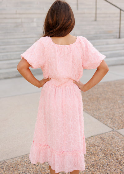 Back view of the pink floral textured little girl dress
