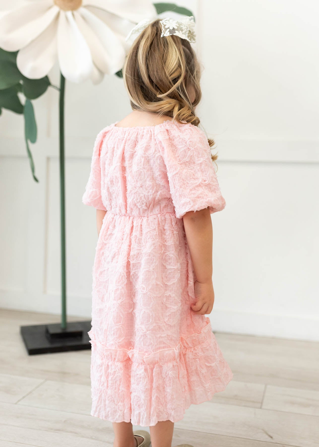 Back view of the pink floral textured little girl dress