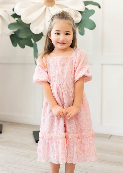 Pink floral textured little girl dress with ruffle at them hem