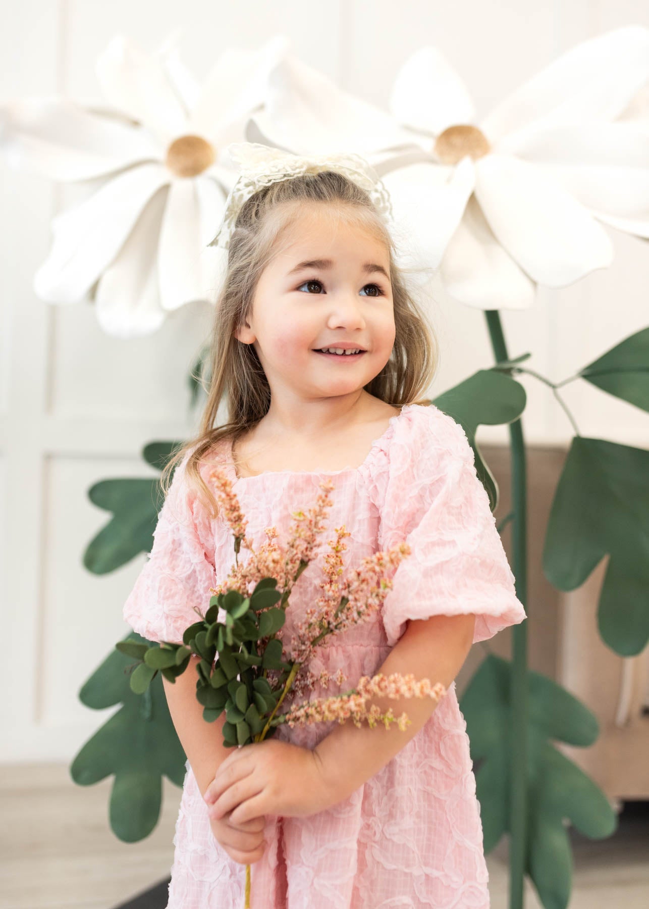 Front view of the pink floral textured little girl dress