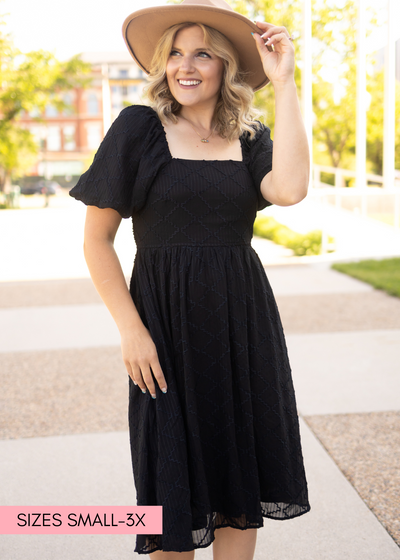 Short sleeve black dress with smocked bodice