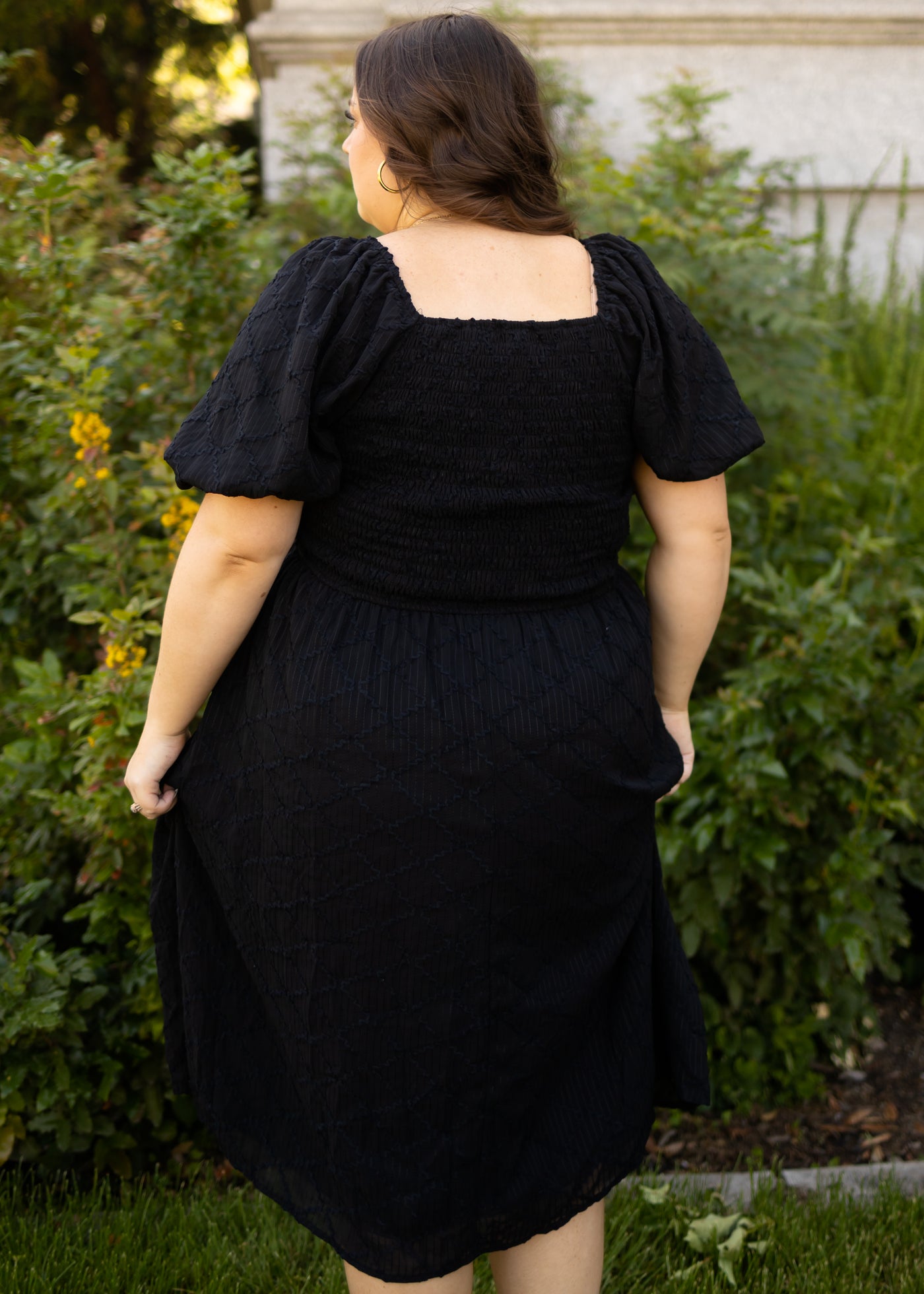 Back view of a plus size black dress