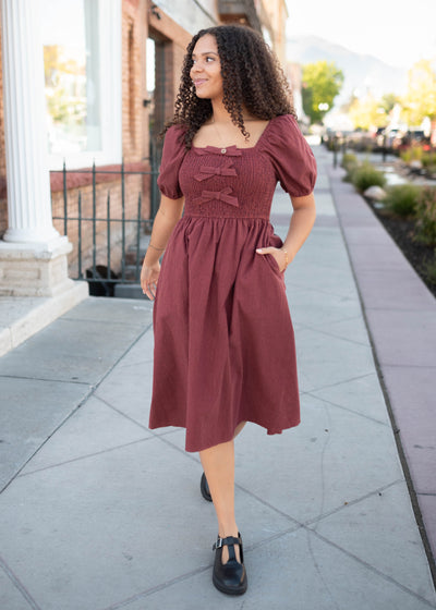 Short sleeve brick gingham bow dress with a smocked bodice