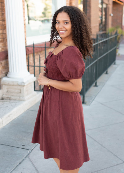 Side view of the brick gingham bow dress