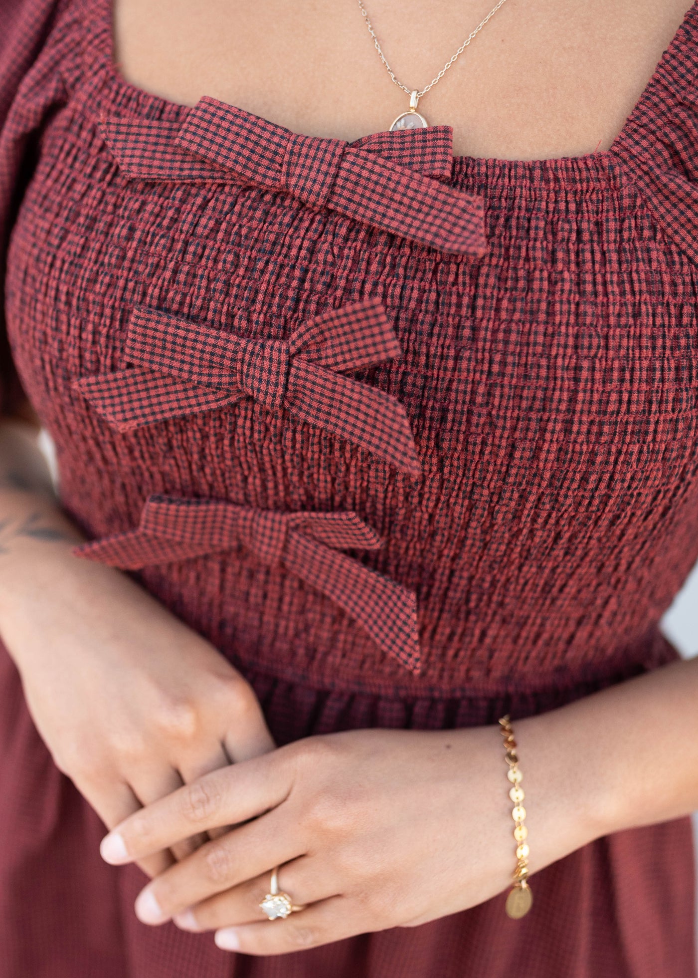 Close up of the bows and smocking on the brick gingham bow dress