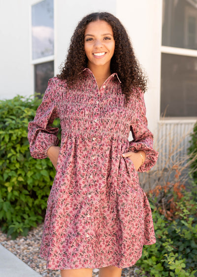 Long sleeve pink floral dress that buttons up and has a collar