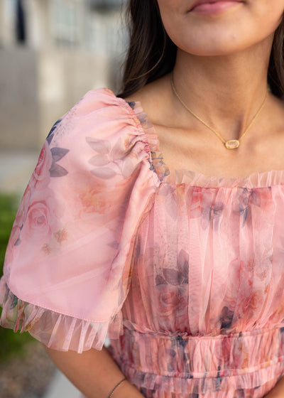 Close up of the fabric and sleeve on the pink floral dress
