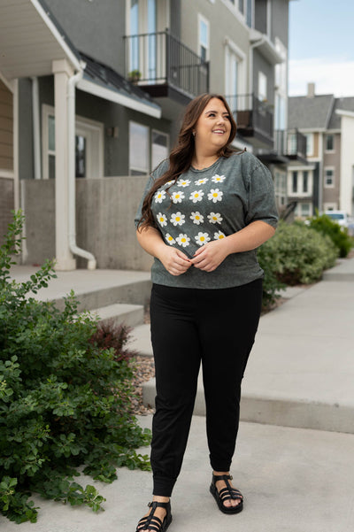 Plus size black joggers with a stone grey tee that has a daisy print that is sold separately 