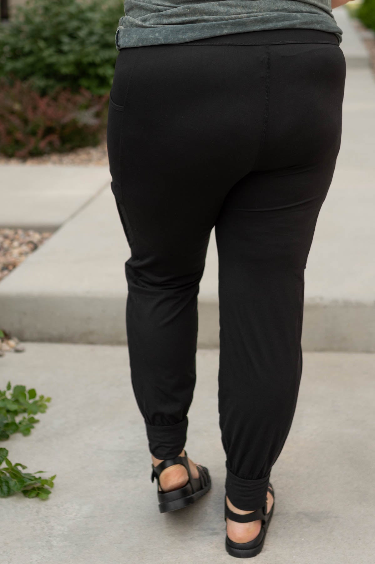 Back view of plus size black joggers