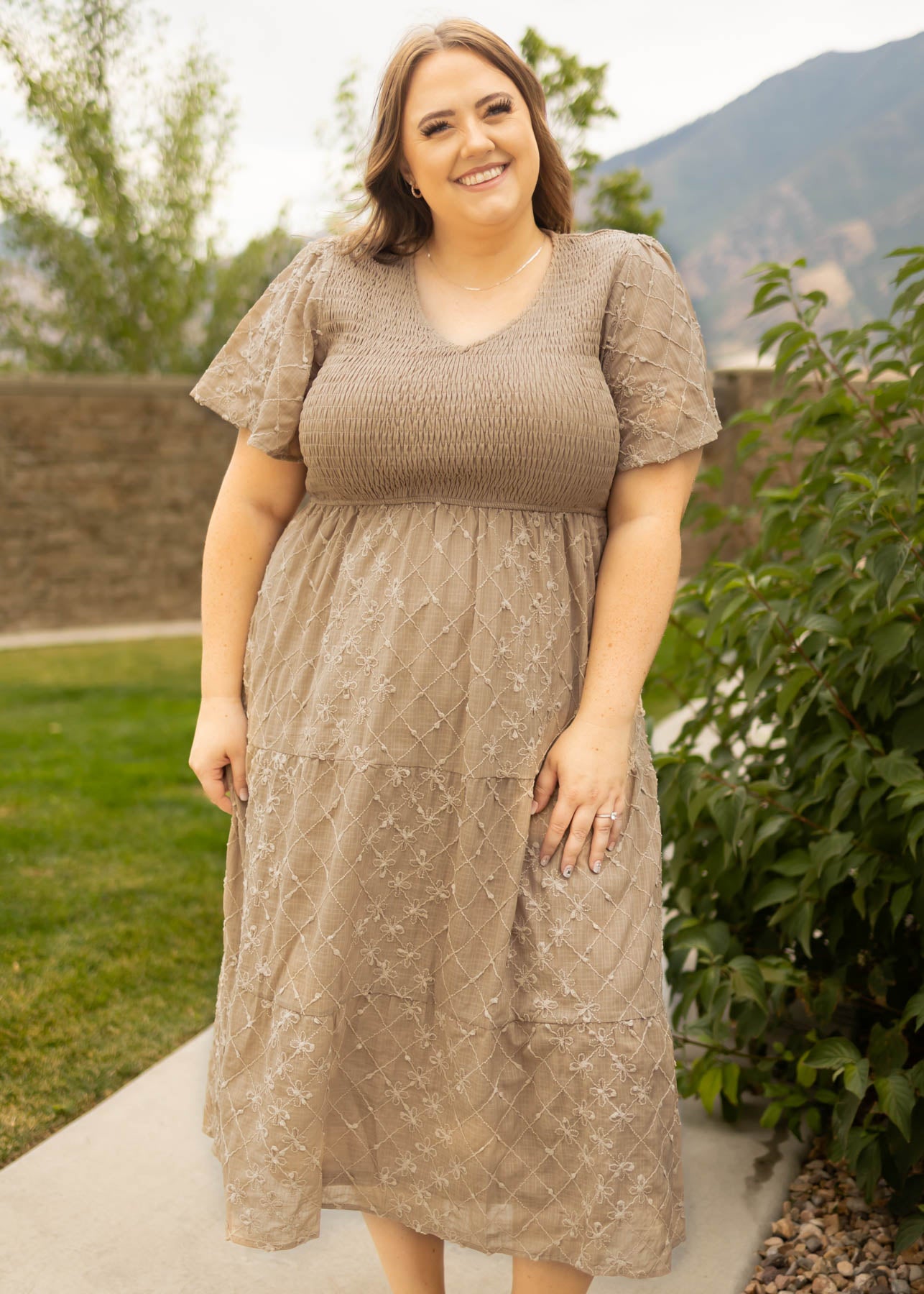 Short sleeve plus size taupe dress with smocked bodice and tiered skirt