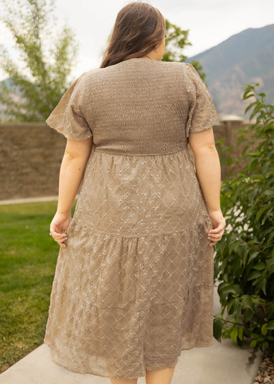 Back view of a plus size taupe dress