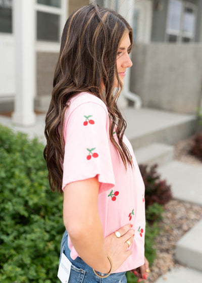 Side view of the cherry pink embroidered top