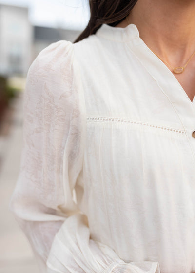 Close up of the fabric on the ivory button down dress