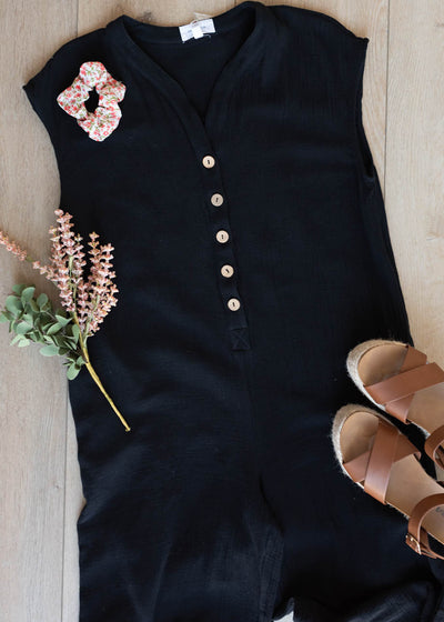 Flat layout of the black button up jumpsuit