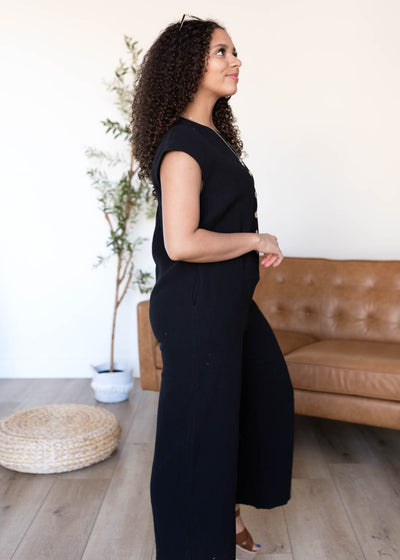 Side view of the black button up jumpsuit