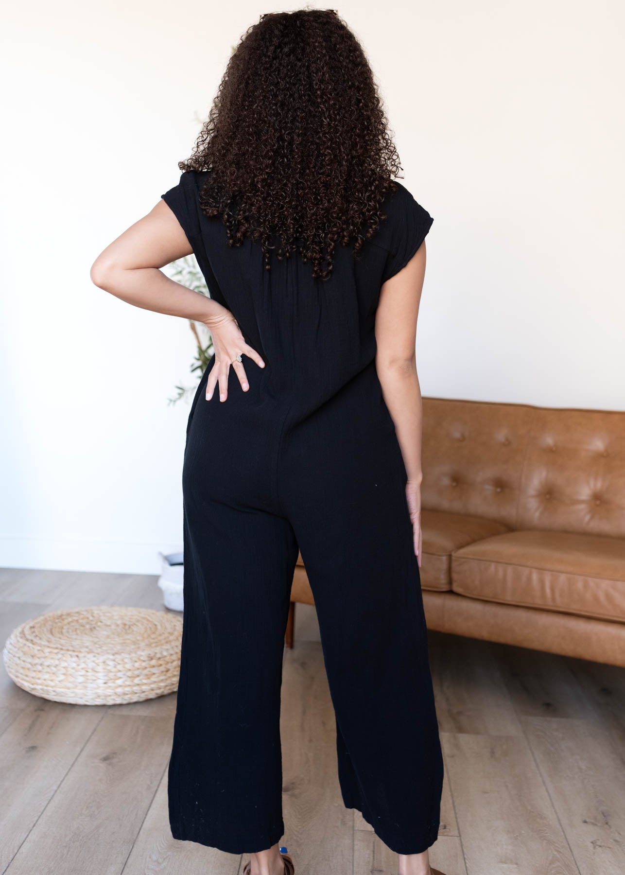 Back view of the black button up jumpsuit