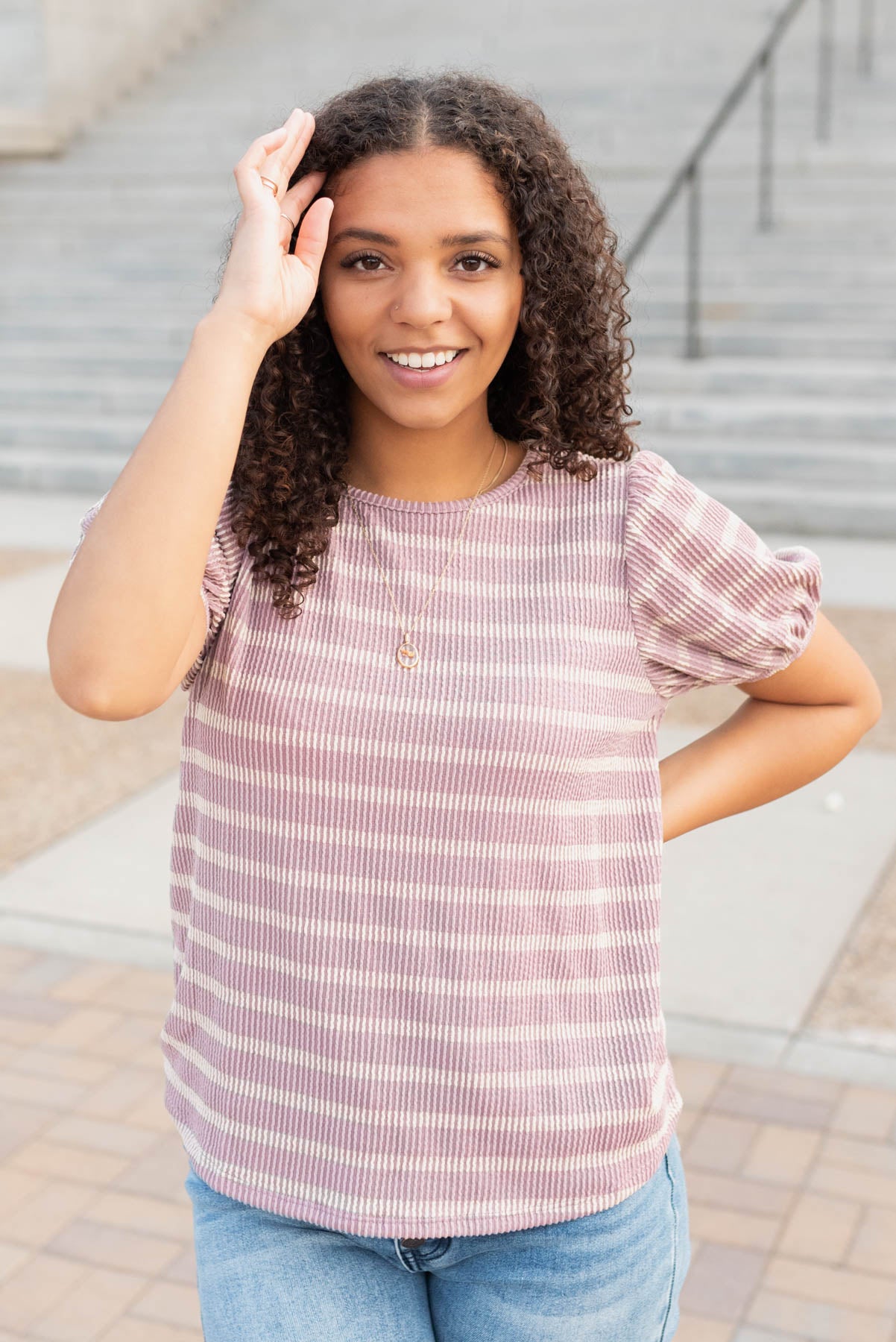 Rolled neck hem on the pink stirpe ribbed top
