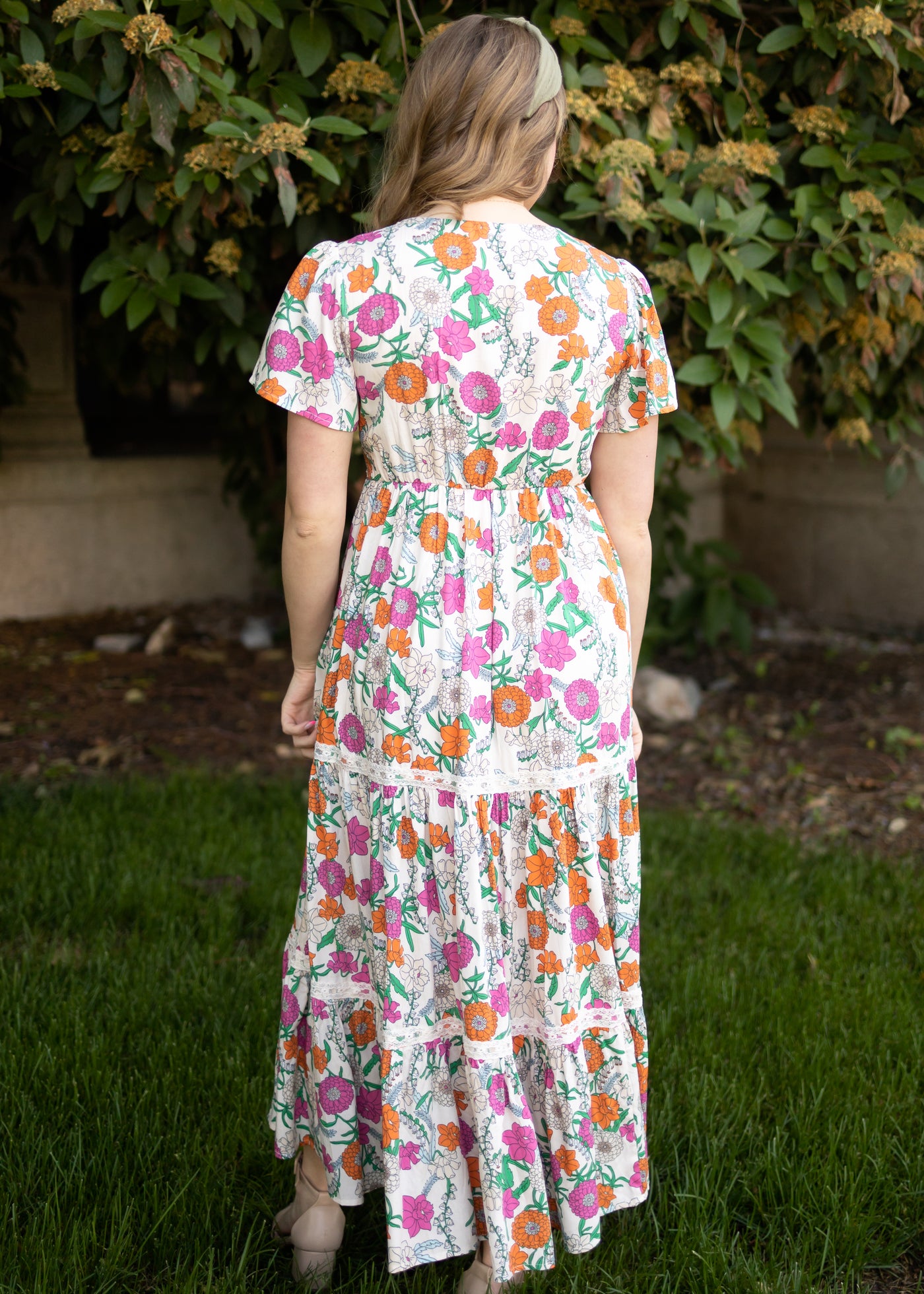 Back view of a tan floral dress
