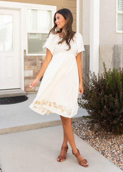 Ivory embroidered dress with embroidery on the neckline and hemline