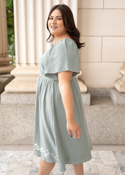 Side view of the light sage embroidered dress in plus size