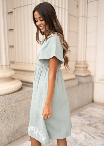 Side view of the light sage embroidered dress