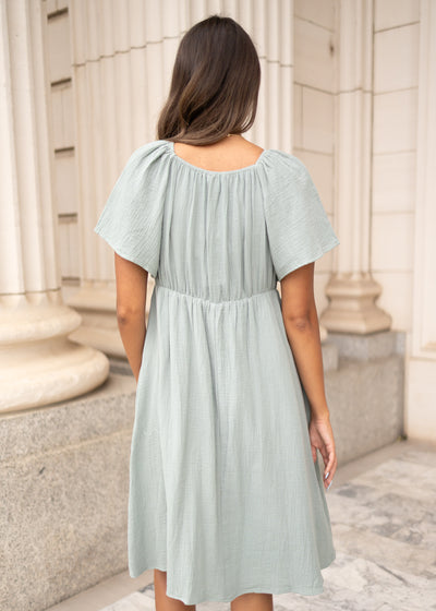 Back view of the light sage embroidered dress