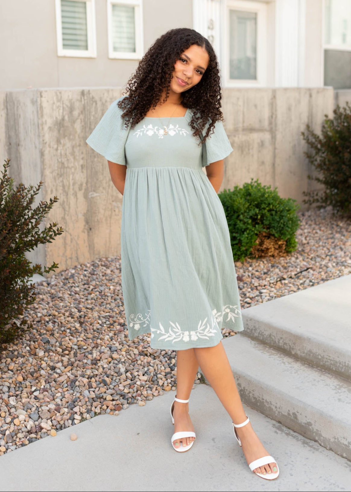 Modest light sage embroidered dress with white embroidery at the hem
