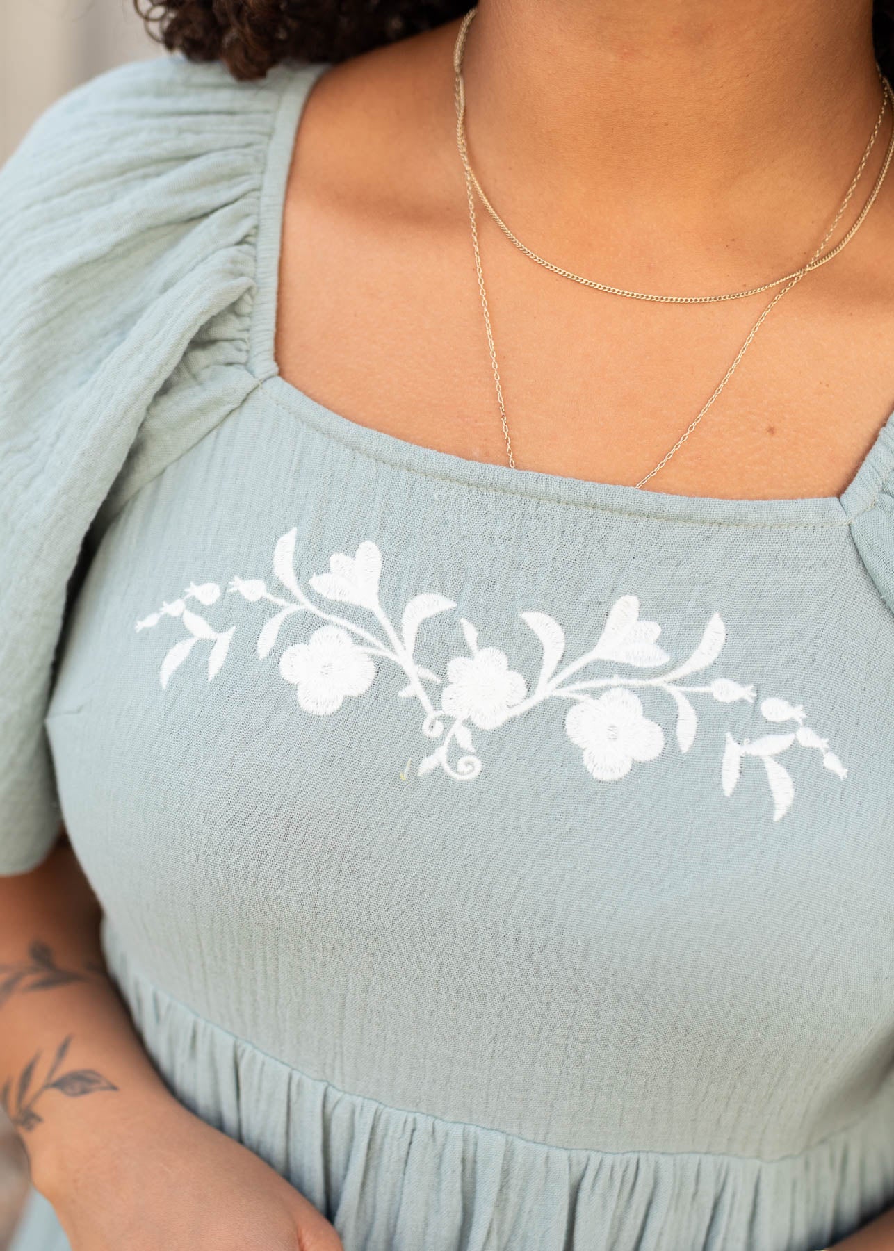 Close up of the embroidery on the modest light sage embroidered dress