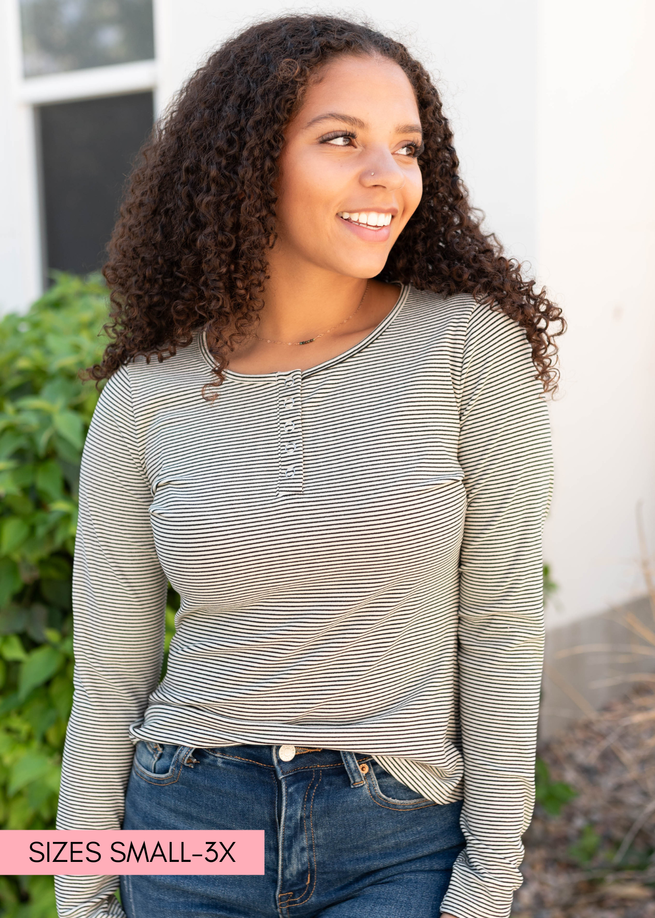 Modest white and black striped top with long sleeves and snaps a the neck