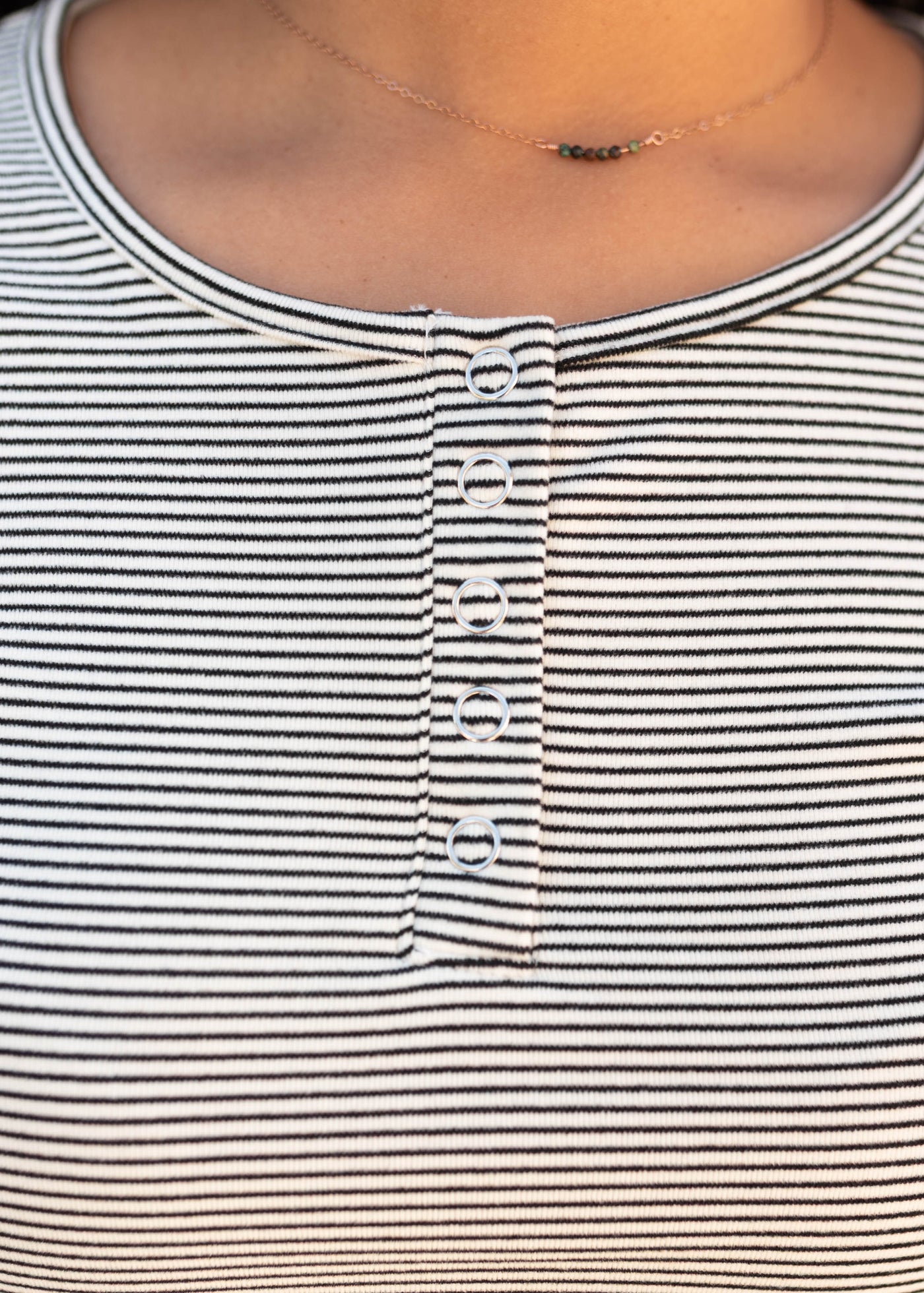 Close up of the snaps on the black striped top