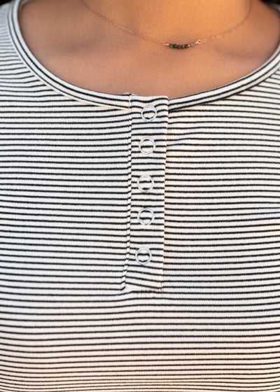 Close up of the snaps on the black striped top