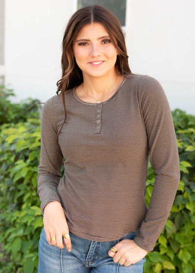 Long sleeve white and brown striped top with snaps at the neck
