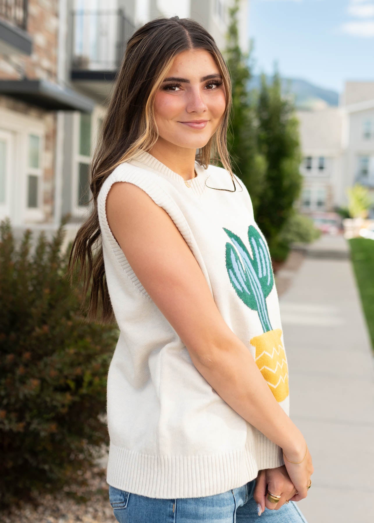 Side view of the sand cactus sweater vest