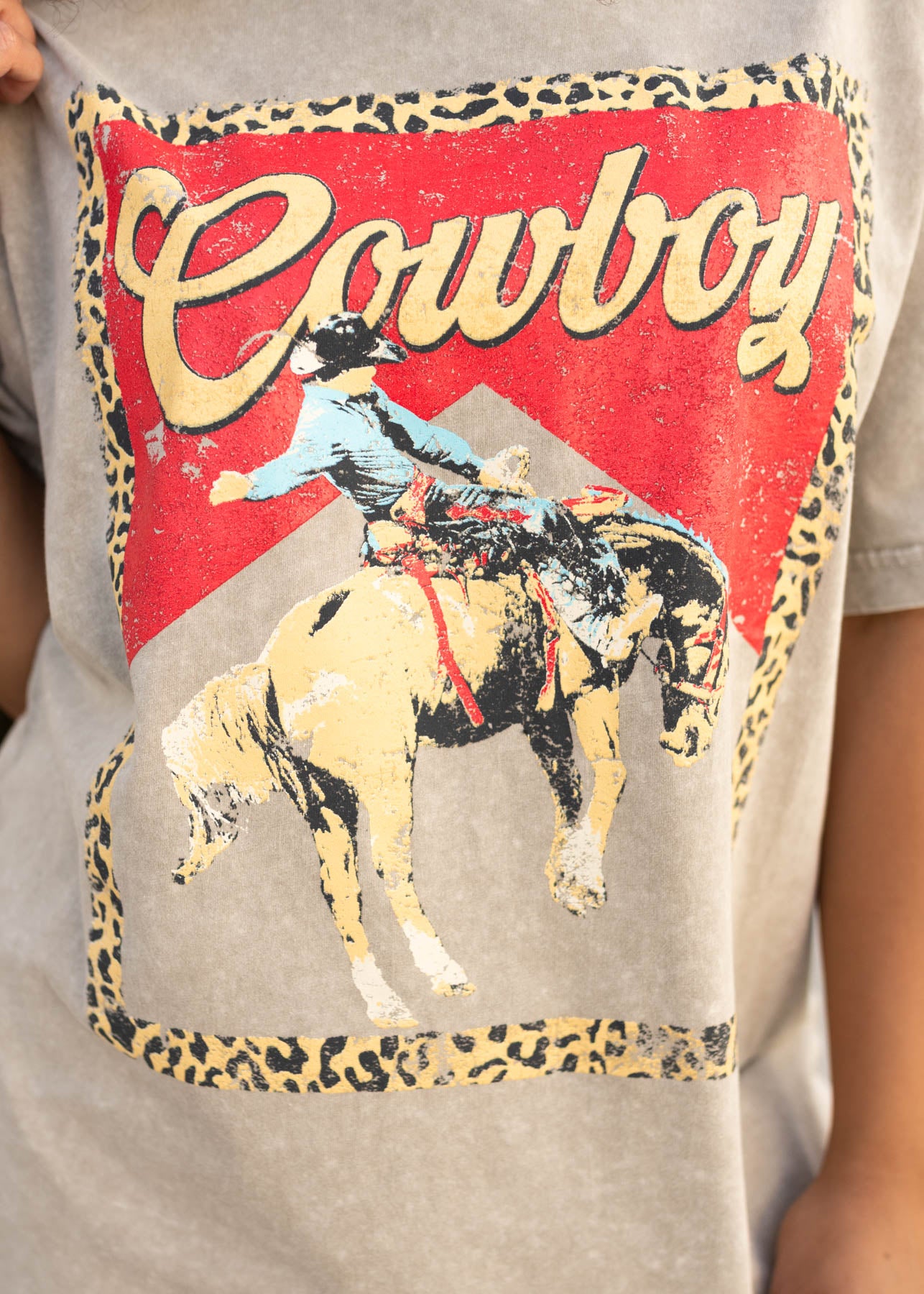 Close up of the graphic with a horse on the light mocha graphic tee