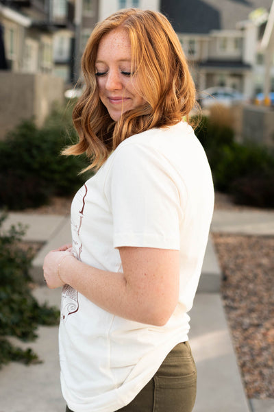 Side view of a cowgirl cream top