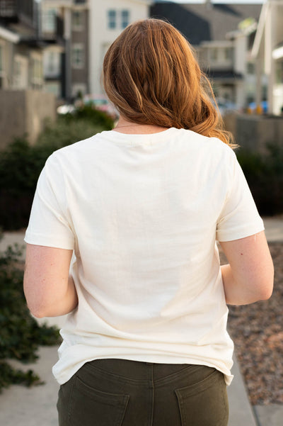 Back view of a cowgirls cream top