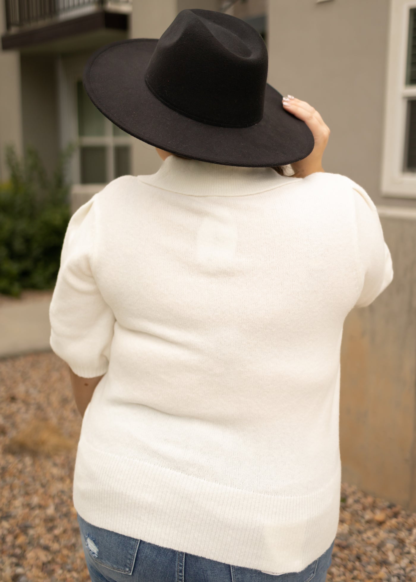 Back view of a plus size ivory top