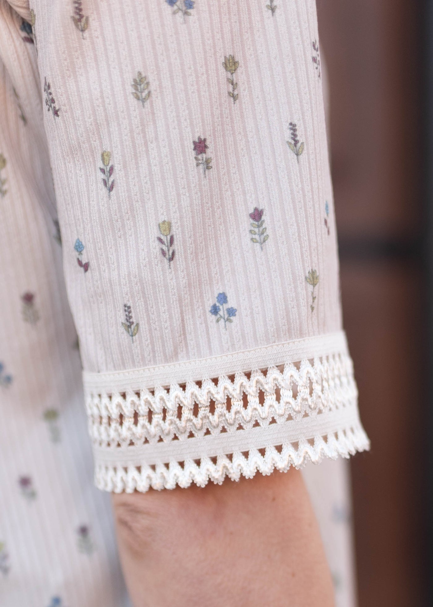 Cream floral top with lace detail on the sleeve