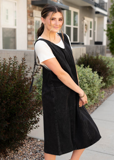 Side view of the black denim overall dress