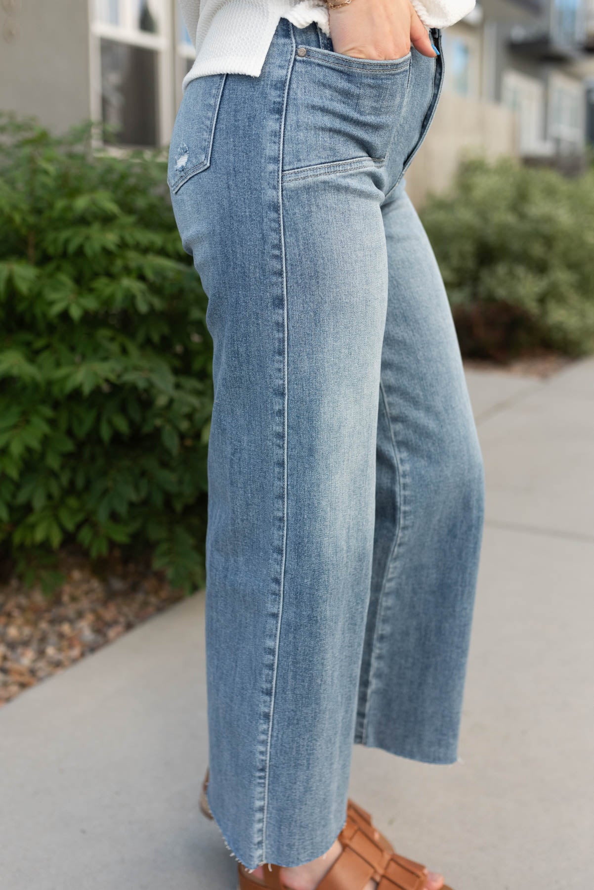 Side view of the medium wash wide leg jeans