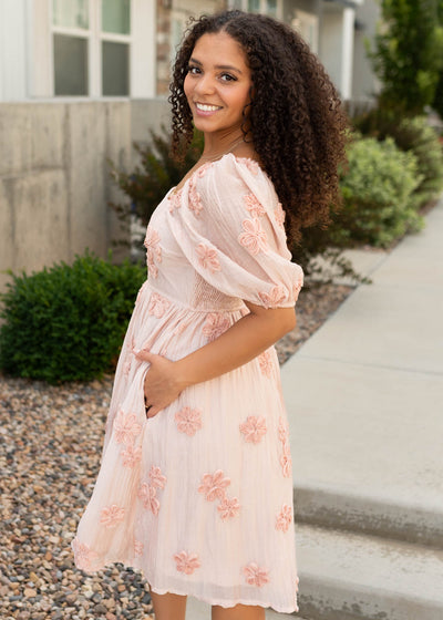 Side view of the blush pink floral dress with pockets