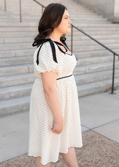 Side view of the plus size ivory polka dot dress